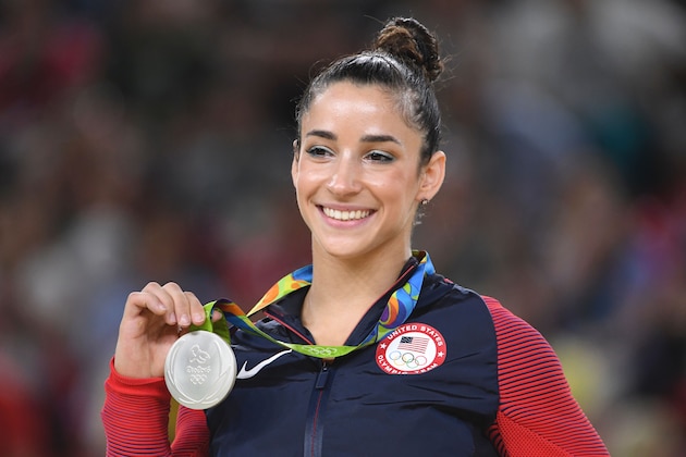 US gymnast Alexandra Raisman celebrates on the podium of the women's floor event final of the Artistic Gymnastics at the Olympic Arena during the Rio 2016 Olympic Games in Rio de Janeiro on August 16, 2016. / AFP / Toshifumi KITAMURA        (Photo credit should read TOSHIFUMI KITAMURA/AFP/Getty Images)