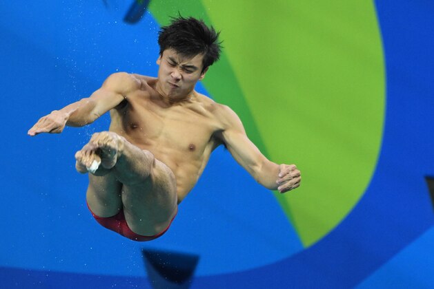 Aug 15, 2016; Rio de Janeiro, Brazil; Yuan Cao (CHN) during the men's 3m preliminary springboard round in the Rio 2016 Summer Olympic Games at Maria Lenk Aquatics Centre. Mandatory Credit: Robert Hanashiro-USA TODAY Sports