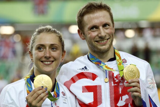 Laura Trott, left, and her fiance Jason Kenny, right, both of Britain, pose with their gold medals at the Rio Olympic Velodrome during the 2016 Summer Olympics in Rio de Janeiro, Brazil, Tuesday, Aug. 16, 2016. Kenny won the men's keirin cycling final and Trott won gold in the women's omnium race.(AP Photo/Patrick Semansky)