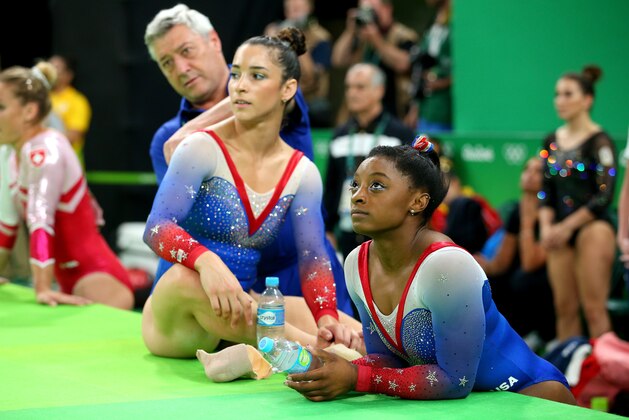 RIO DE JANEIRO, BRAZIL - AUGUST 16:  Simone Biles (R) and Alexandra Raisman (L) of the United States watch Vanessa Ferrari of Italy competing on the Women's Floor Final on Day 11 of the Rio 2016 Olympic Games at the Rio Olympic Arena on August 16, 2016 in Rio de Janeiro, Brazil.  (Photo by Alex Livesey/Getty Images)
