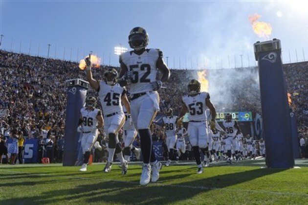 Los Angeles Rams players run out of the tunnel before a preseason NFL football game against the Dallas Cowboys, Saturday, Aug. 13, 2016, in Los Angeles. (AP Photo/Mark J. Terrill)