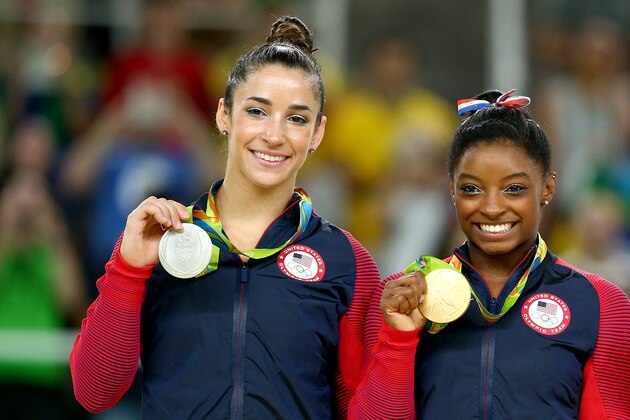RIO DE JANEIRO, BRAZIL - AUGUST 16:  Silver medalist Alexandra Raisman (L) and gold medalist Simone Biles (R) of the United States pose for photographs on the podium at the medal ceremony for the Women's Floor on Day 11 of the Rio 2016 Olympic Games at the Rio Olympic Arena on August 16, 2016 in Rio de Janeiro, Brazil.  (Photo by Alex Livesey/Getty Images)