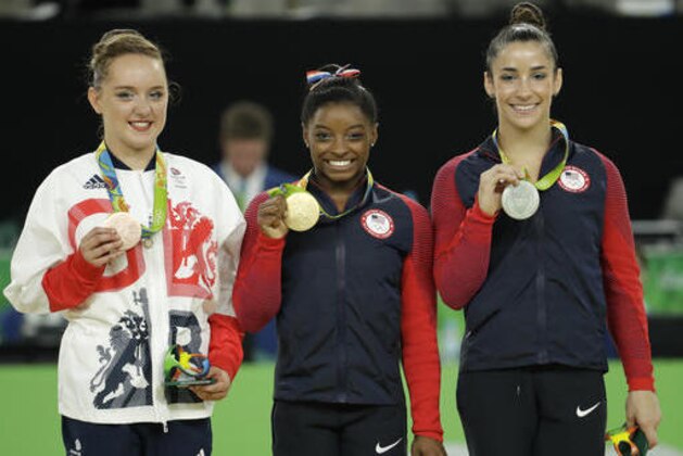From right, United States' Aly Raisman, silver for floor, compatriot Simone Biles, gold, and Britain's Amy Tinkler, silver, display their medals during the artistic gymnastics women's apparatus final at the 2016 Summer Olympics in Rio de Janeiro, Brazil, Tuesday, Aug. 16, 2016. (AP Photo/Dmitri Lovetsky)