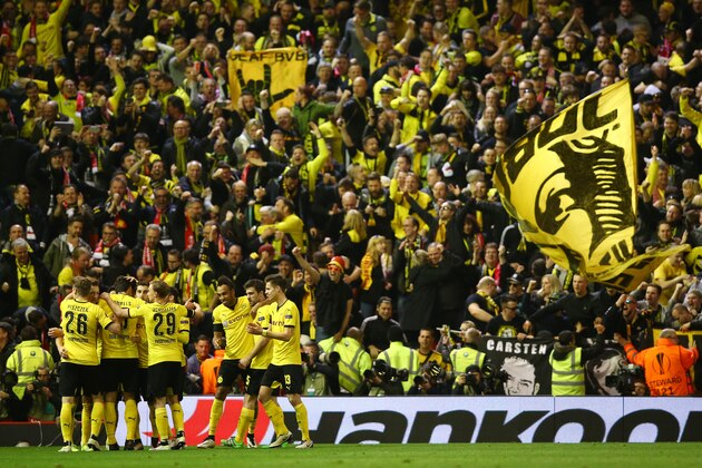 LIVERPOOL, ENGLAND - APRIL 14: Borussia Dortmund players and fans celebrate the third goal scored by Marco Reus during the UEFA Europa League quarter final, second leg match between Liverpool and Borussia Dortmund at Anfield on April 14, 2016 in Liverpool, United Kingdom.  (Photo by Clive Brunskill/Getty Images)