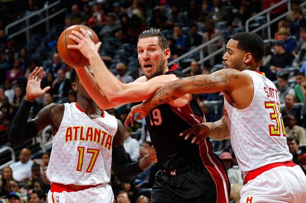 ATLANTA, GA - FEBRUARY 19:  Beno Udrih #19 of the Miami Heat drives against Mike Scott #32 of the Atlanta Hawks at Philips Arena on February 19, 2016 in Atlanta, Georgia.  NOTE TO USER User expressly acknowledges and agrees that, by downloading and or using this photograph, user is consenting to the terms and conditions of the Getty Images License Agreement.  (Photo by Kevin C. Cox/Getty Images)