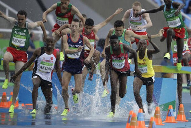 Athletes compete in a men's 3000-meter steeplechase heat during the athletics competitions of the 2016 Summer Olympics at the Olympic stadium in Rio de Janeiro, Brazil, Monday, Aug. 15, 2016. (AP Photo/Natacha Pisarenko)