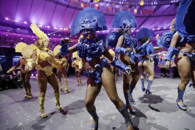 FILE - In this Friday, Aug. 5, 2016, file photo, dancers perform during the opening ceremony for the 2016 Summer Olympics in Rio de Janeiro. NBC and other television networks around the world are offering selected Olympic events, including the opening and closing ceremonies, in virtual reality for the first time, but television remains the go-to place for a truly immersive experience. (AP Photo/David J. Phillip, File)