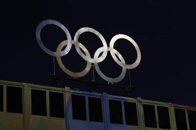 Sun reflects in Olympic rings prior to a women's beach volleyball quarterfinal match between Germany and Canada at the 2016 Summer Olympics in Rio de Janeiro, Brazil, Sunday, Aug. 14, 2016. (AP Photo/Petr David Josek)
