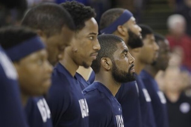 United States' Kyrie Irving, center, and teammates listen to the National anthem during an exhibition basketball game against China Tuesday, July 26, 2016, in Oakland, Calif. (AP Photo/Marcio Jose Sanchez)