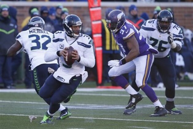 Seattle Seahawks quarterback Russell Wilson (3) looks for a receiver during the first half of an NFL wild-card football game against the Minnesota Vikings, Sunday, Jan. 10, 2016, in Minneapolis. (AP Photo/Jim Mone)