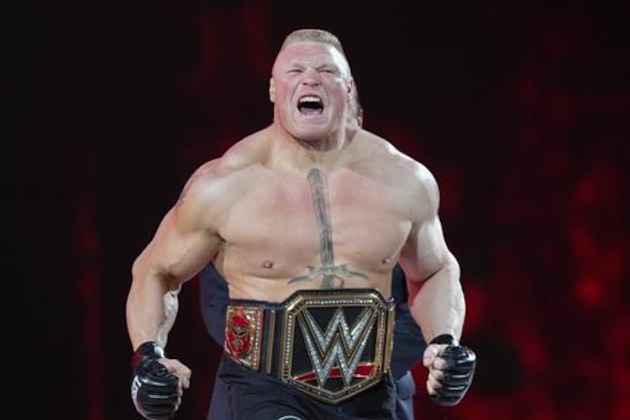 FILE - In this March 29, 2015, file photo, Brock Lesnar makes his entrance at Wrestlemania XXXI in Santa Clara, Calif. Lesnar, the former WWE and UFC heavyweight champion, was selected Monday, June 27, 2016, as the cover superstar for the WWE 2K17 video game that is set for an Oct. 11 release.  (AP Photo/Don Feria, File)