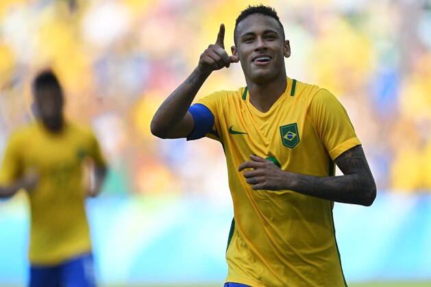 Brazil's Neymar celebrates after scoring a penalty against Honduras during their Rio 2016 Olympic Games men's football semifinal match at the Maracana stadium in Rio de Janeiro, Brazil, on August 17, 2016. / AFP / Martin BERNETTI        (Photo credit should read MARTIN BERNETTI/AFP/Getty Images)