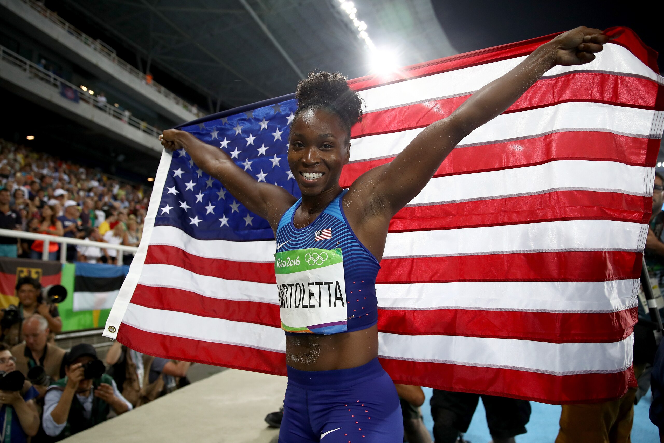 RIO DE JANEIRO, BRAZIL - AUGUST 17:  Tianna Bartoletta of the United States celebrates with the American flag after winning the gold medal in the Women's Long Jump Final on Day 12 of the Rio 2016 Olympic Games at the Olympic Stadium on August 17, 2016 in Rio de Janeiro, Brazil.  (Photo by Cameron Spencer/Getty Images)