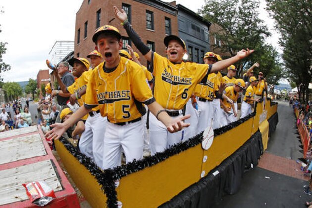 The team from Goodlettsville, Tenn., rides in the Little League Grand Slam Parade in downtown Williamsport, Pa., Wednesday, Aug. 17, 2016. The Little League World Series baseball tournament starts Thursday in South Williamsport, Pa. (AP Photo/Gene J. Puskar)