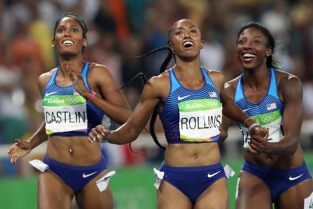 Gold medal winner Brianna Rollins, center, silver medal winner, Nia Ali, right, and bronze medal winner Kristi Castlin, all from the United States, pose with their country's flag after the 100-meter hurdles final,during the athletics competitions of the 2016 Summer Olympics at the Olympic stadium in Rio de Janeiro, Brazil, Wednesday, Aug. 17, 2016. (AP Photo/Lee Jin-man)