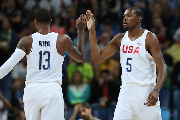 Aug 12, 2016; Rio de Janeiro, Brazil; United States forward Kevin Durant (5) high-fives guard Paul George (13) during the game in the preliminary round against Serbia of the Rio 2016 Summer Olympic Games at Carioca Arena 1. Mandatory Credit: Jason Getz-USA TODAY Sports