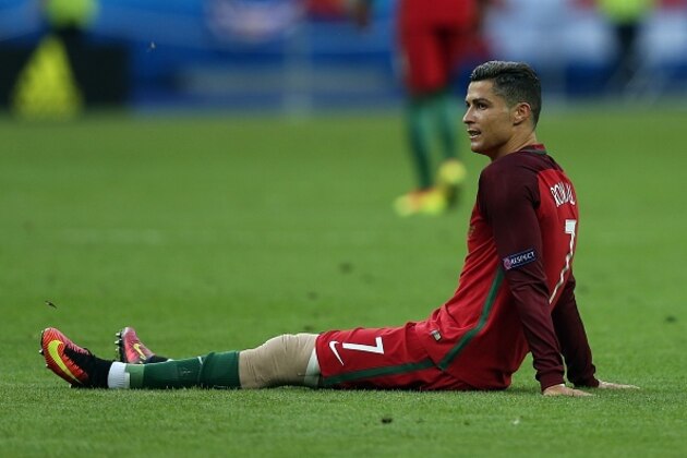 PARIS, FRANCE - JULY 10: Cristiano Ronaldo of Portugal lies injured during the UEFA Euro 2016 Final match between Portugal and France at Stade de France on July 10, 2016 in Paris, France. (Photo by Chris Brunskill Ltd/Getty Images)