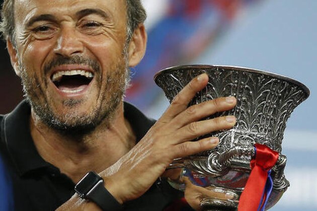 FC Barcelona's coach Luis Enrique celebrates with the trophy after winning the Spanish Super Cup between FC Barcelona and Sevilla at the Camp Nou in Barcelona, Spain, Thursday, Aug. 18, 2016. (AP Photo/Manu Fernandez) FC Barcelona's coach Luis Enrique celebrates with the trophy after winning the Spanish Super Cup between FC Barcelona and Sevilla at the Camp Nou in Barcelona, Spain, Thursday, Aug. 18, 2016. (AP Photo/Manu Fernandez)
