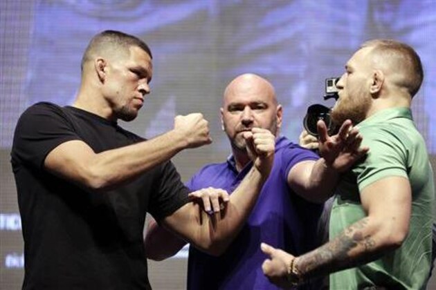 Dana White, center, stands between Nate Diaz, left, and Conor McGregor during a UFC 202 mixed martial arts news conference, Thursday, July 7, 2016, in Las Vegas. Diaz and McGregor are scheduled to fight at UFC 202 in Las Vegas. (AP Photo/John Locher)