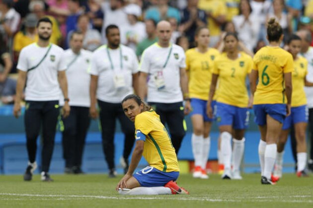 Brazil's Marta, front, reacts after a penalty shootout during a semifinal match of the women's Olympic football tournament between Brazil and Sweden at the Maracana stadium in Rio de Janeiro Aug. 16, 2016. Sweden qualified for the final after beating Brazil on penalty kicks. (AP Photo/Silvia Izquierdo)