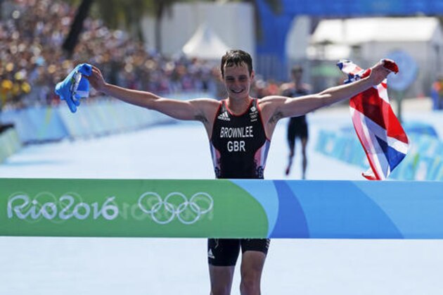 Britain's Alistair Brownlee crosses the finish line to win the the men's triathlon event at the 2016 Summer Olympics in Rio de Janeiro, Brazil, Thursday, Aug. 18, 2016. (AP Photo/David Goldman)