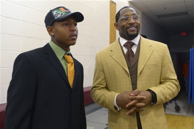 FILE - In this Feb. 6, 2013, file photo, Ray Anthony Lewis III, left, and his father, former Baltimore Ravens linebacker Ray Lewis Jr., chat after his national signing day ceremony in the Lake Mary Prep auditorium in Lake Mary, Fla. Lewis III, a Coastal Carolina defensive back, is charged with third-degree criminal sexual conduct. An arrest warrant issued Friday, April 29, 2016, said the charge stems from a Jan. 23 incident at a Conway, S.C., apartment and alleges 20-year-old Lewis engaged in sex with an 18-year-old woman incapacitated from using drugs or alcohol. (AP Photo/Phelan M. Ebenhack, File)