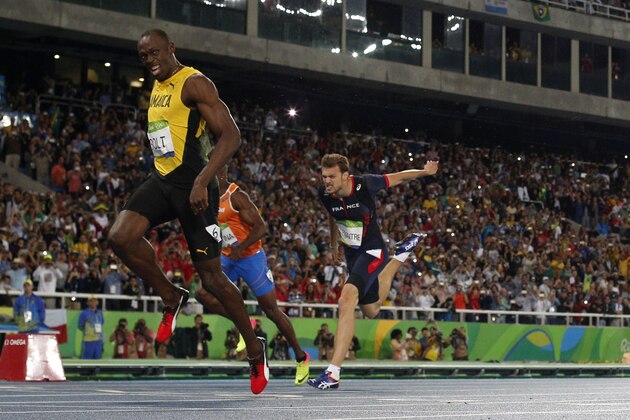 Jamaica's Usain Bolt wins the Men's 200m Final ahead of bronze medallist France's Christophe Lemaitre during the athletics event at the Rio 2016 Olympic Games at the Olympic Stadium in Rio de Janeiro on August 18, 2016.   / AFP / Adrian DENNIS        (Photo credit should read ADRIAN DENNIS/AFP/Getty Images)