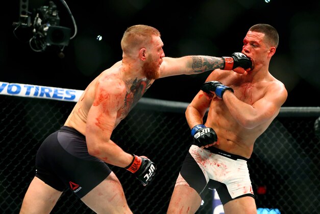March 5, 2016; Las Vegas, NV, USA; Conor McGregor (left) punches Nate Diaz in the face during UFC 196 at MGM Grand Garden Arena. Mandatory Credit: Mark J. Rebilas-USA TODAY Sports