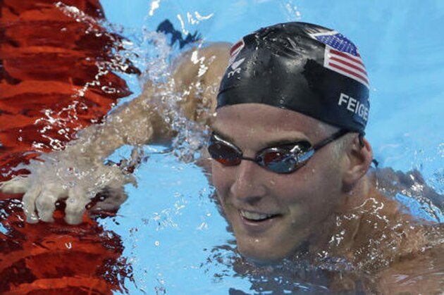 FILE - In this Aug. 2, 2016, file photo, United States James Feigen smiles during a swimming training session prior to the 2016 Summer Olympics in Rio de Janeiro, Brazil. Feigen was one of four American Olympic swimmers in connection to a story of being held at gunpoint and robbed several hours after the last Olympic swimming races ended. That claim began to unravel when police said that investigators could not find evidence to substantiate it. (AP Photo/Matt Slocum, File)