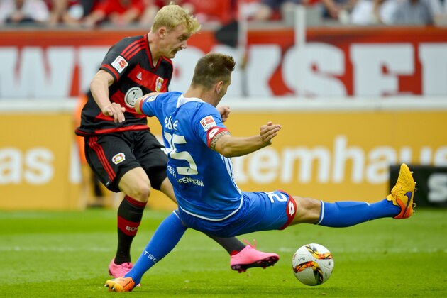 Leverkusen's midfielder Julian Brandt (L) scores 2-1 next to Hoffenheim's defender Niklas Suele during the German first division Bundesliga football match Bayer 04 Leverkusen vs TSG 1899 Hoffenheim in Leverkusen, western Germany, on August 15, 2015. AFP PHOTO / SASCHA SCHUERMANN  RESTRICTIONS: DURING MATCH TIME: DFL RULES TO LIMIT THE ONLINE USAGE TO 15 PICTURES PER MATCH AND FORBID IMAGE SEQUENCES TO SIMULATE VIDEO.  == RESTRICTED TO EDITORIAL USE == FOR FURTHER QUERIES PLEASE CONTACT DFL DIRECTLY AT + 49 69 650050.        (Photo credit should read SASCHA SCHUERMANN/AFP/Getty Images)