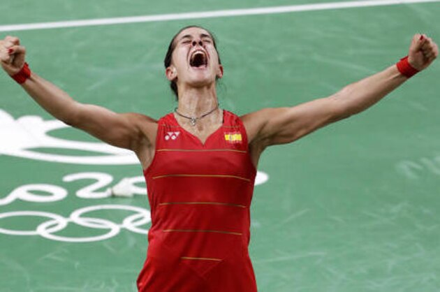Spain's Carolina Marin celebrates after defeating India's V. Sindhu Pusarla to win the women's badminton singles gold medal match at the 2016 Summer Olympics in Rio de Janeiro, Brazil, Friday, Aug. 19, 2016. (AP Photo/Mark Humphrey)