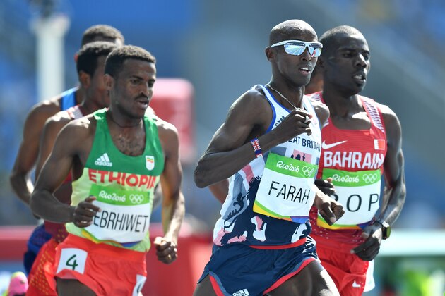 Britain's Mo Farah (C) competes with Ethiopia's Hagos Gebrhiwet (L) and Bahrain's Albert Kibichii Rop in the Men's 5000m Round 1 during the athletics event at the Rio 2016 Olympic Games at the Olympic Stadium in Rio de Janeiro on August 17, 2016.   / AFP / Jewel SAMAD        (Photo credit should read JEWEL SAMAD/AFP/Getty Images)
