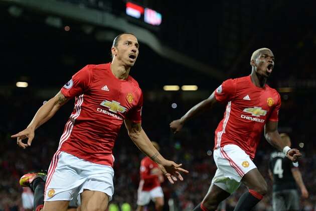 Manchester United's Swedish striker Zlatan Ibrahimovic (L) celebrates with Manchester United's French midfielder Paul Pogba after scoring their second goal from the penalty spot during the English Premier League football match between Manchester United and Southampton at Old Trafford in Manchester, north west England, on August 19, 2016. / AFP / Oli SCARFF / RESTRICTED TO EDITORIAL USE. No use with unauthorized audio, video, data, fixture lists, club/league logos or 'live' services. Online in-match use limited to 75 images, no video emulation. No use in betting, games or single club/league/player publications.  /         (Photo credit should read OLI SCARFF/AFP/Getty Images)