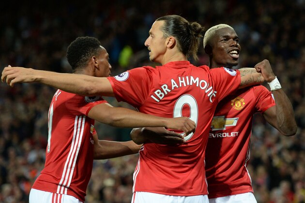 Manchester United's Swedish striker Zlatan Ibrahimovic (C) celebrates with Manchester United's French midfielder Paul Pogba (R) and Manchester United's French striker Anthony Martial after scoring their second goal from the penalty spot during the English Premier League football match between Manchester United and Southampton at Old Trafford in Manchester, north west England, on August 19, 2016. / AFP / Oli SCARFF / RESTRICTED TO EDITORIAL USE. No use with unauthorized audio, video, data, fixture lists, club/league logos or 'live' services. Online in-match use limited to 75 images, no video emulation. No use in betting, games or single club/league/player publications.  /         (Photo credit should read OLI SCARFF/AFP/Getty Images)
