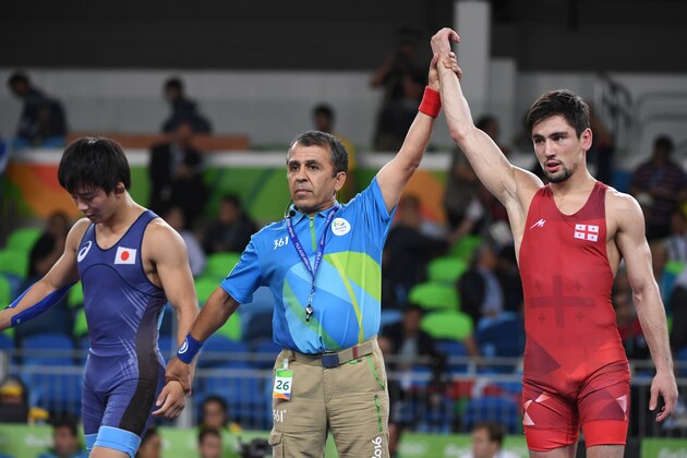 Georgia's Vladimer Khinchegashvili (R) celebrates after winning against Japan's Rei Higuchi in their men's 57kg freestyle final match on August 19, 2016, during the wrestling event of the Rio 2016 Olympic Games at the Carioca Arena 2 in Rio de Janeiro. / AFP / Toshifumi KITAMURA        (Photo credit should read TOSHIFUMI KITAMURA/AFP/Getty Images)