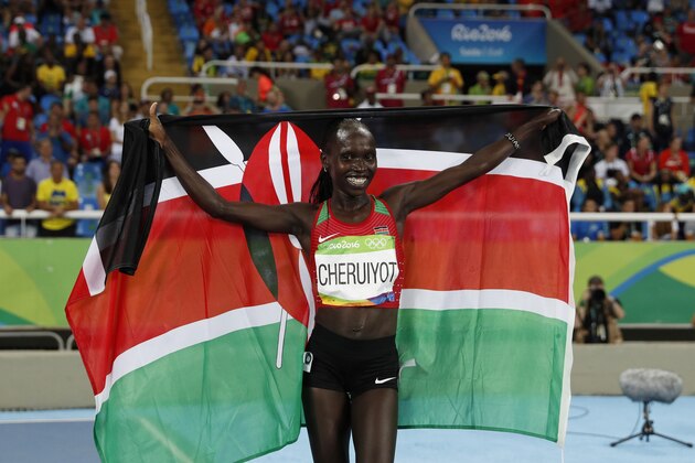 Kenya's Vivian Jepkemoi Cheruiyot celebrates her victory in the Women's 5000m Final during the athletics event at the Rio 2016 Olympic Games at the Olympic Stadium in Rio de Janeiro on August 19, 2016.   / AFP / Adrian DENNIS        (Photo credit should read ADRIAN DENNIS/AFP/Getty Images)