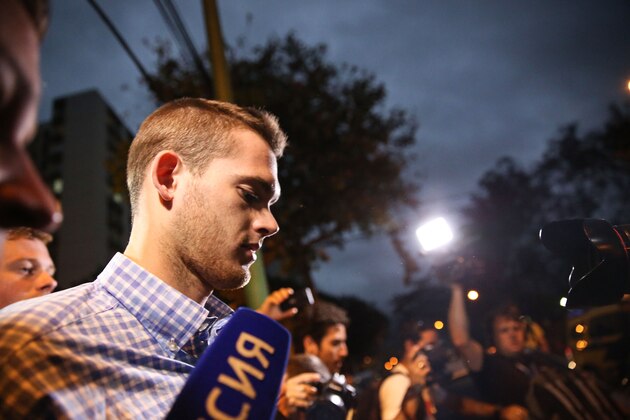 RIO DE JANEIRO, BRAZIL - AUGUST 18:  U.S Olympic swimmers Gunnar Bentz (CENTER R) and Jack Conger (LOWER L) leave a police station after being questioned on August 18, 2016 in Rio de Janeiro, Brazil. Ryan Lochte, Gunnar Bentz, Jack Conger and Jimmy Feigen were involved in an altercation at a gas station on Sunday, according to published reports.  Bentz and Conger were detained by Brazilian authorities last night while attempting to fly out of Brazil. Their claims of being victims of a late-night robbery were being questioned by police. (Photo by Mario Tama/Getty Images)