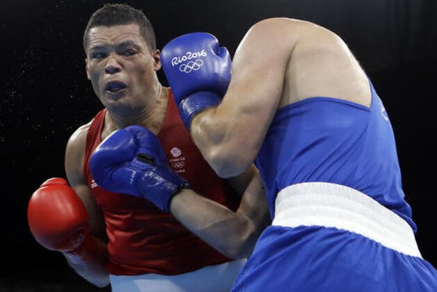 Britain's Joe Joyce, left, fights Kazakhstan's Ivan Dychko during a men's super heavyweight over 91-kg semifinals boxing match at the 2016 Summer Olympics in Rio de Janeiro, Brazil, Friday, Aug. 19, 2016. (AP Photo/Frank Franklin II)