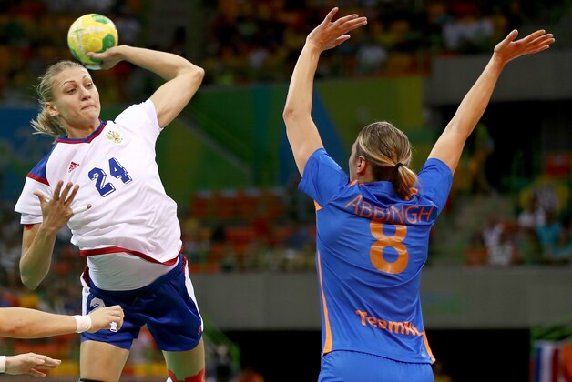 RIO DE JANEIRO, BRAZIL - AUGUST 14:  Irina Bliznova #24 of Russia takes a shot as Lois Abbingh #8 of Netherlands defends on Day 9 of the Rio 2016 Olympic Games at the Future Arena on August 14, 2016 in Rio de Janeiro, Brazil.  (Photo by Elsa/Getty Images)