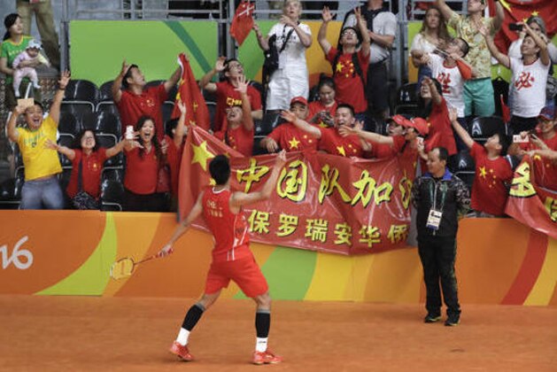 China's Chen Long tosses a racquet into the crowd after defeating Malaysia's Lee Chong Wei to win the men's badminton singles gold medal match at the 2016 Summer Olympics in Rio de Janeiro, Brazil, Saturday, Aug. 20, 2016. (AP Photo/Mark Humphrey)