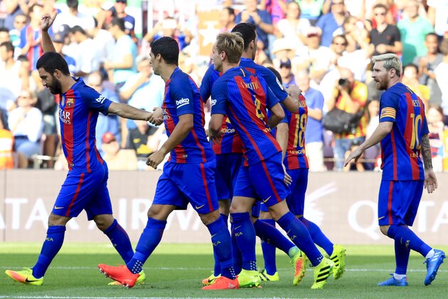 Barcelona's Turkish midfielder Arda Turan (L) celebrates with teammates after scoring during the Spanish league football match FC Barcelona vs Real Betis Balompie at the Camp Nou stadium in Barcelona on August 20, 2016. / AFP / PAU BARRENA        (Photo credit should read PAU BARRENA/AFP/Getty Images)