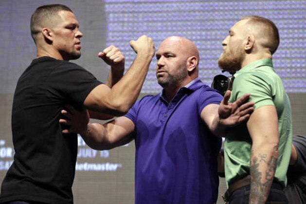 FILE - In this July 7, 2016, file photo, Dana White, center, stands between Nate Diaz, left, and Conor McGregor during a news conference in Las Vegas for UFC 202. Diaz beat McGregor by submission in the second round of a welterweight bout March 5 at UFC 196, ending McGregor's 15-fight winning streak. McGregor had asked for a quick rematch and it was scheduled during the landmark UFC 200 card in July, but McGregor announced he was retiring during the spring. He later relented, but by then UFC had dropped him from that card. Saturday's rematch was announced in June. (AP Photo/John Locher, File)