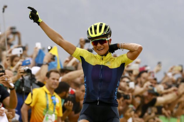 Jenny Rissveds of Sweden celebrates as she crosses the finish line to win the women's cross-country mountain bike race at the 2016 Summer Olympics in Rio de Janeiro, Brazil, Saturday, Aug. 20, 2016. (AP Photo/Patrick Semansky)