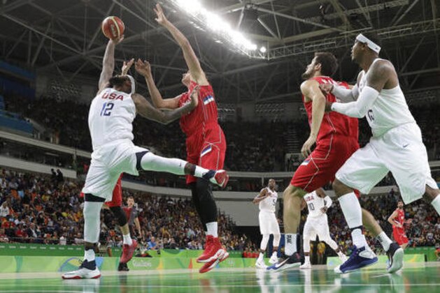 United States' DeMarcus Cousins (12) pulls down a reoubnd against Serbia's Nikola Jokic (14) during a men's basketball game at the 2016 Summer Olympics in Rio de Janeiro, Brazil, Friday, Aug. 12, 2016. (AP Photo/Eric Gay)