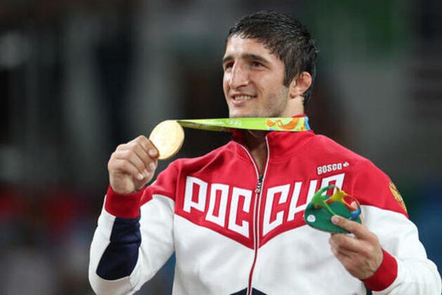 Russia's Abdulrashid Sadulaev displays his gold medal after winning the men's 86-kg freestyle wrestling competition at the 2016 Summer Olympics in Rio de Janeiro, Brazil, Saturday, Aug. 20, 2016. (AP Photo/Petr David Josek)