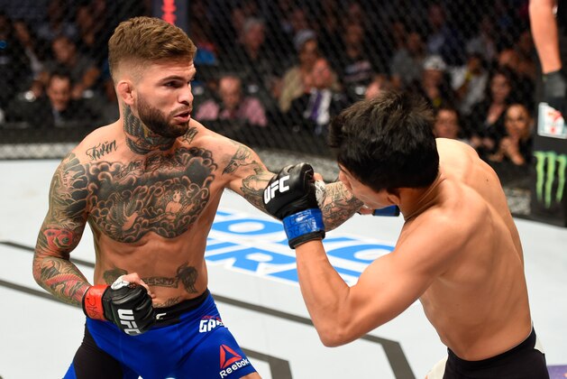 LAS VEGAS, NV - AUGUST 20:  Cody Garbrandt punches Takeya Mizugaki of Japan in their bantamweight bout during the UFC 202 event at T-Mobile Arena on August 20, 2016 in Las Vegas, Nevada.  (Photo by Josh Hedges/Zuffa LLC/Zuffa LLC via Getty Images)