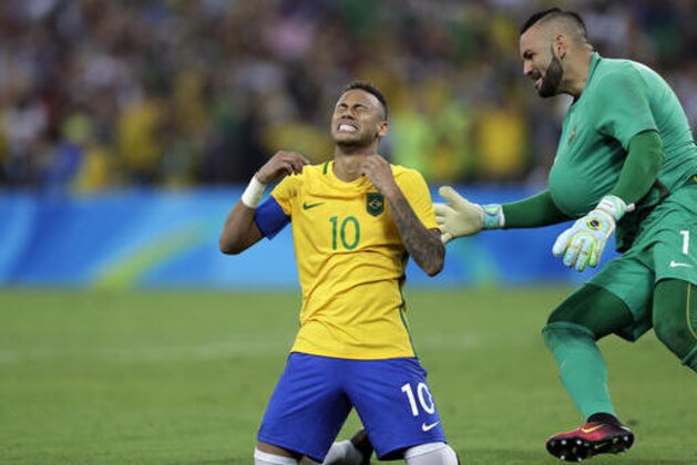 Brazil's Neymar cries as he kneels down to celebrate with teammate goalkeeper Weverton after scoring the decisive penalty kick during the final match of the men's Olympic football tournament between Brazil and Germany at the Maracana stadium in Rio de Janeiro, Brazil, Saturday Aug. 20, 2016. Brazil won the gold medal on  a penalty shootout. (AP Photo/Andre Penner)