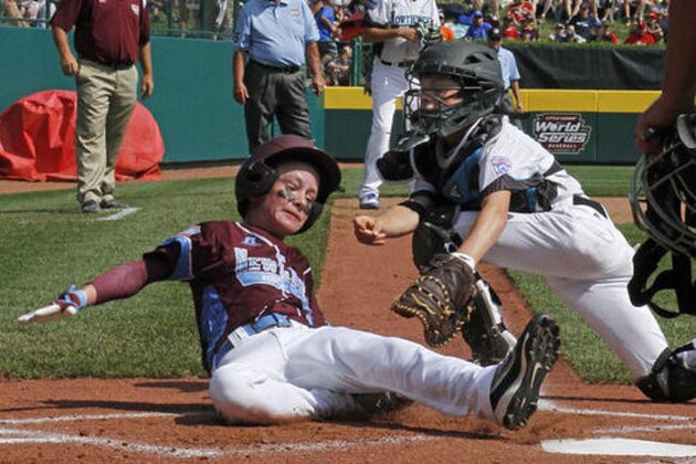 Bend, Ore., catcher Joe Schultz, right, tags out Warwick, R.I.'s Aaron Narcavage who was attempting to score on a foul ball to right field during the first inning of an United States elimination baseball game at the Little League World Series tournament in South Williamsport, Pa., Saturday, Aug. 20, 2016.   (AP Photo/Gene J. Puskar)