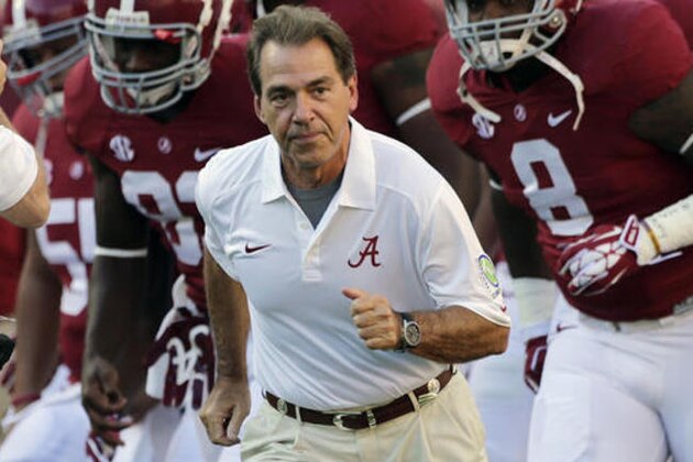 FILE - In this Sept. 28, 2013, file photo, Alabama head coach Nick Saban leads his team onto the field prior to an NCAA college football game against Mississippi in Tuscaloosa, Ala. The defending national champion Crimson Tide is the No. 1 team in The Associated Press preseason Top 25 for the fifth time overall and third time under coach Nick Saban. (AP Photo/Dave Martin, File)