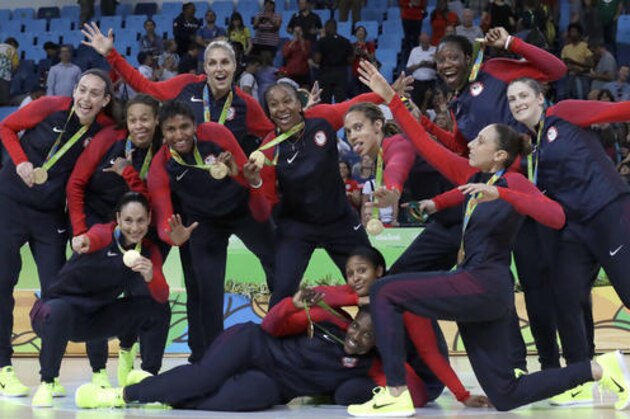 Members of the United States basketball team pose their gold medals after their win over Spain in a women's basketball game at the 2016 Summer Olympics in Rio de Janeiro, Brazil, Saturday, Aug. 20, 2016. (AP Photo/Eric Gay)